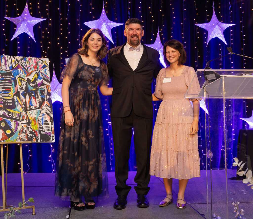 Tom Whitehead, Emily Whitehead and Jodie Potter smiling at the Believe Ball